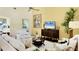 Cozy living room featuring vaulted ceilings, stylish furnishings, and lots of natural light at 175 Inlets Blvd # 175, Nokomis, FL 34275