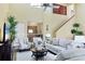 Inviting living room with vaulted ceiling, comfortable seating, and a staircase leading to the upper level at 175 Inlets Blvd # 175, Nokomis, FL 34275