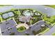 An aerial view showcases the community's clubhouse, pool, tennis courts, parking area, and landscaping features near the lake at 17817 Pastureland Ave, Lakewood Ranch, FL 34211