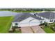 Aerial view of the community with lake, landscaping, and paver driveways at 17817 Pastureland Ave, Lakewood Ranch, FL 34211