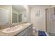 Modern bathroom features double sink vanity with granite counters and glass-enclosed shower at 17817 Pastureland Ave, Lakewood Ranch, FL 34211