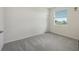 Empty bedroom showing carpeted floor, one window, and a door to the side at 17817 Pastureland Ave, Lakewood Ranch, FL 34211