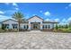 Beautiful, light and bright clubhouse with well manicured landscaping, palm trees, and paver entry at 17817 Pastureland Ave, Lakewood Ranch, FL 34211