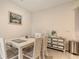 Light and airy dining area featuring seating for four and beach-themed decor at 17817 Pastureland Ave, Lakewood Ranch, FL 34211