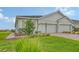 Well-maintained home with a two-car garage, brick driveway, and beautiful landscaping adding curb appeal at 17817 Pastureland Ave, Lakewood Ranch, FL 34211