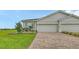 Charming home with a two-car garage, brick driveway, and lush green lawn, perfect for a Gathering at 17817 Pastureland Ave, Lakewood Ranch, FL 34211