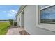The side of a house with a brick walkway, fresh landscaping and an area to be able to relax and sit at 17817 Pastureland Ave, Lakewood Ranch, FL 34211