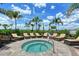 Relaxing hot tub surrounded by lounge chairs and lush landscaping with bright blue skies at 17817 Pastureland Ave, Lakewood Ranch, FL 34211