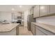 Open kitchen with gray cabinets, subway tile backsplash, and stainless steel appliances at 17817 Pastureland Ave, Lakewood Ranch, FL 34211