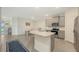 Spacious kitchen featuring modern stainless appliances, gray cabinets and breakfast bar at 17817 Pastureland Ave, Lakewood Ranch, FL 34211