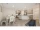 Modern kitchen with stainless steel appliances, island with seating, and an adjacent dining area at 17817 Pastureland Ave, Lakewood Ranch, FL 34211