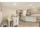Spacious open kitchen with grey cabinetry, stainless steel appliances, and an island with bar stools at 17817 Pastureland Ave, Lakewood Ranch, FL 34211