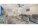 Cozy living room featuring a comfortable couch, stylish rug, and a ceiling fan at 17817 Pastureland Ave, Lakewood Ranch, FL 34211