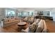 Bright lounge area featuring sofas, chairs, kitchen, and large windows with exterior view at 17817 Pastureland Ave, Lakewood Ranch, FL 34211