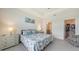 Bright main bedroom with tray ceilings and en suite bathroom at 17817 Pastureland Ave, Lakewood Ranch, FL 34211