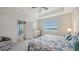Sunny bedroom boasts serene water views and sliding door to outdoor patio at 17817 Pastureland Ave, Lakewood Ranch, FL 34211