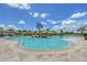 Resort-style pool with lounge chairs, umbrellas, and palm trees in a tropical setting at 17817 Pastureland Ave, Lakewood Ranch, FL 34211