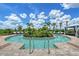 Stunning spa surrounded by lounge chairs and lush landscaping with a bright blue sky at 17817 Pastureland Ave, Lakewood Ranch, FL 34211