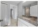 Bathroom features a granite countertop, white cabinets, and tiled floors at 181 Monica St, Port Charlotte, FL 33954