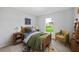 Cozy bedroom with a wooden bed frame, colorful decor, and a bright window at 181 Monica St, Port Charlotte, FL 33954