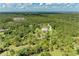 Aerial perspective of a serene property with pond and wooded area at 20207 71St E Ave, Bradenton, FL 34211