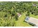 A captivating aerial view of a pool home surrounded by lush greenery, water, and a detached garage at 20207 71St E Ave, Bradenton, FL 34211