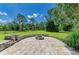 Brick paver backyard patio featuring a built-in fire pit and lots of seating area at 20207 71St E Ave, Bradenton, FL 34211