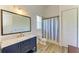 Stylish bathroom showcases a blue vanity with marble top, a large mirror, and a shower-tub combo at 20207 71St E Ave, Bradenton, FL 34211