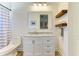 Charming bathroom features a vanity with marble countertop and decorative floating shelves at 20207 71St E Ave, Bradenton, FL 34211