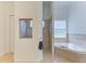 Bathroom featuring a tiled shower, soaking tub, and tile floors at 20207 71St E Ave, Bradenton, FL 34211