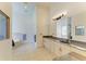 Large bathroom features dual sinks, tiled floors, a soaking tub, and a glass-enclosed shower at 20207 71St E Ave, Bradenton, FL 34211