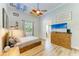 Comfortable bedroom with natural light, wooden floors, and TV over a matching dresser at 20207 71St E Ave, Bradenton, FL 34211