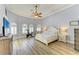 Spacious bedroom with a tray ceiling, lots of light, and a decorative ceiling fan at 20207 71St E Ave, Bradenton, FL 34211