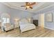 Bedroom with a tray ceiling, neutral walls, a ceiling fan, and lots of bright, natural light at 20207 71St E Ave, Bradenton, FL 34211