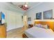 Cozy bedroom features a wooden bed frame, stylish decor, and ample closet space at 20207 71St E Ave, Bradenton, FL 34211