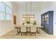 Spacious dining area with wood floors, large windows, modern light fixture and decorative hutch at 20207 71St E Ave, Bradenton, FL 34211