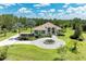 A front elevation features lush tropical landscaping, a circular driveway, and mature trees at 20207 71St E Ave, Bradenton, FL 34211