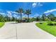 A front elevation features lush tropical landscaping, a circular driveway, and a well-manicured lawn at 20207 71St E Ave, Bradenton, FL 34211