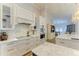 Well-equipped kitchen featuring white cabinets, marble backsplash, and modern appliances at 20207 71St E Ave, Bradenton, FL 34211