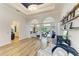 Bright open living space with hardwood floors, arched doorways, decorative pillars, and backyard access at 20207 71St E Ave, Bradenton, FL 34211