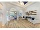 Bright open living space with hardwood floors, arched doorways, decorative pillars, and backyard access at 20207 71St E Ave, Bradenton, FL 34211