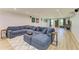 Open-concept living room area with a large sofa, recessed lights, and vinyl floors at 20207 71St E Ave, Bradenton, FL 34211
