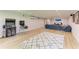 Spacious entertainment room with a large sectional sofa and an array of arcade games at 20207 71St E Ave, Bradenton, FL 34211