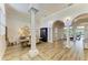 Bright open living space with hardwood floors, arched doorways, and elegant decorative pillars at 20207 71St E Ave, Bradenton, FL 34211