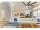 Bright living room with a comfortable sofa, a ceiling fan, and a view of the adjacent kitchen at 20207 71St E Ave, Bradenton, FL 34211