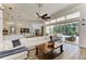 Inviting living room with sliding glass doors to the pool area and a comfortable sectional sofa at 20207 71St E Ave, Bradenton, FL 34211
