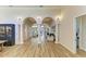 Bright open living space with hardwood floors, arched doorways, decorative pillars, and backyard access at 20207 71St E Ave, Bradenton, FL 34211