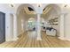 Bright open living space with hardwood floors, arched doorways, decorative pillars, and backyard access at 20207 71St E Ave, Bradenton, FL 34211