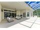 The covered patio is set up as an outdoor living space with comfortable furniture and convenient access to the home at 20207 71St E Ave, Bradenton, FL 34211