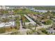 An aerial view shows the property nestled in a vibrant community with lush greenery and convenient parking at 2155 Wood St # A26, Sarasota, FL 34237